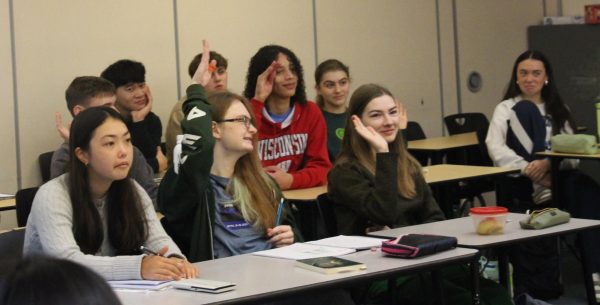 Raising hands to see who eats peanut butter every day, AP Lit students participate in A Random Minute (ARM).
