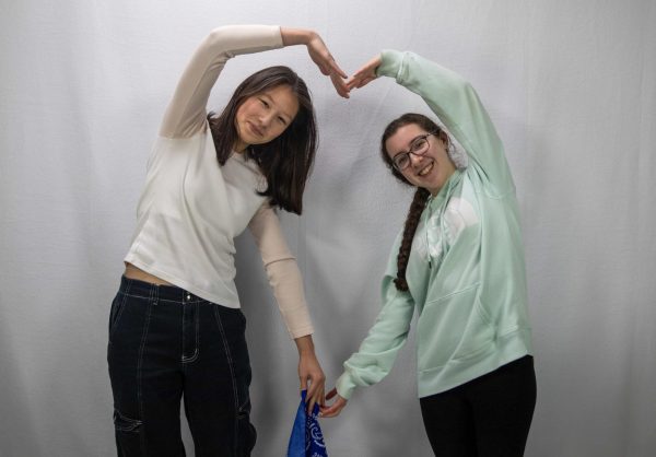 Clara Wood and Kira Sato, seniors, pose for a photo after receiving their dark blue bandana, the color that would represent them for the rest of the Race.