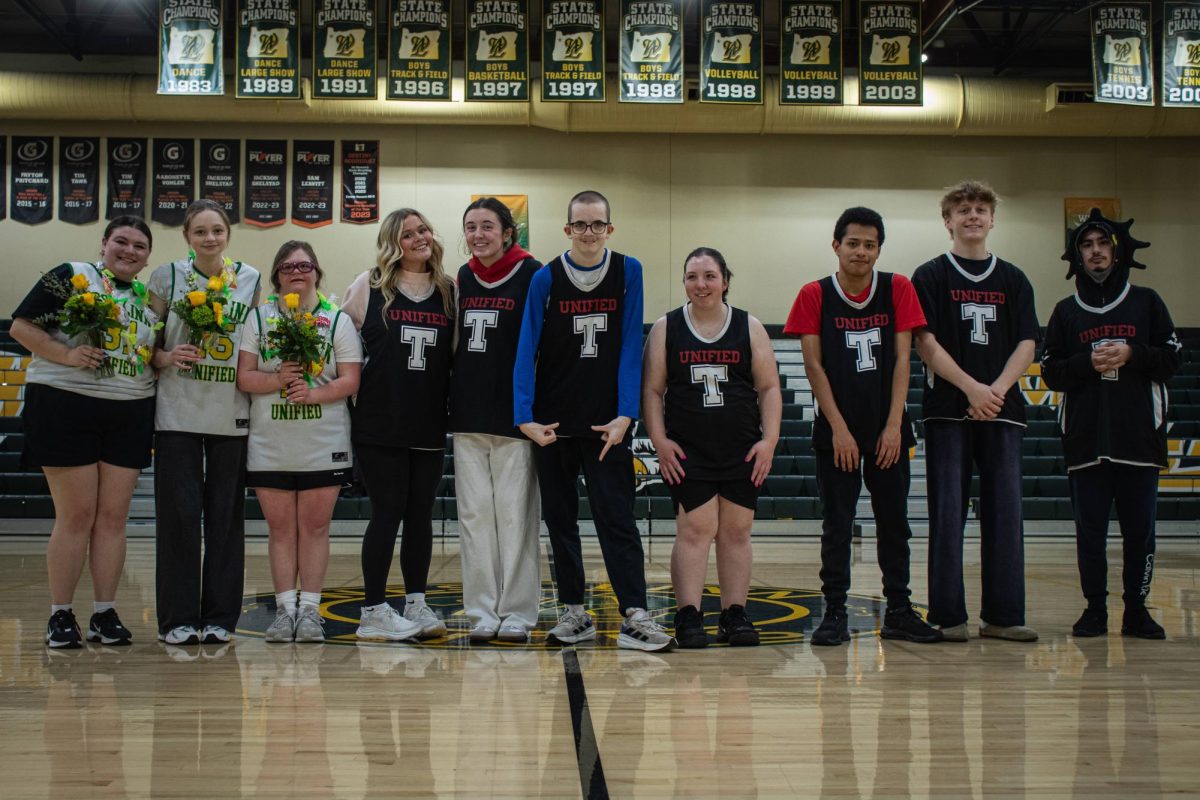 During halftime, seniors on both teams line up on halfcourt to receive their flowers.
