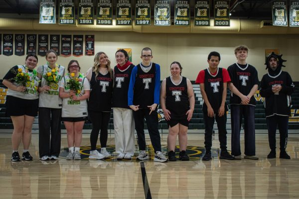 During halftime, seniors on both teams line up on halfcourt to receive their flowers.