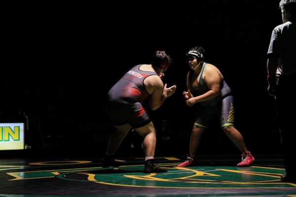 Justin Mariscal, junior, wrestles his opponent during Wrestling's senior night.
