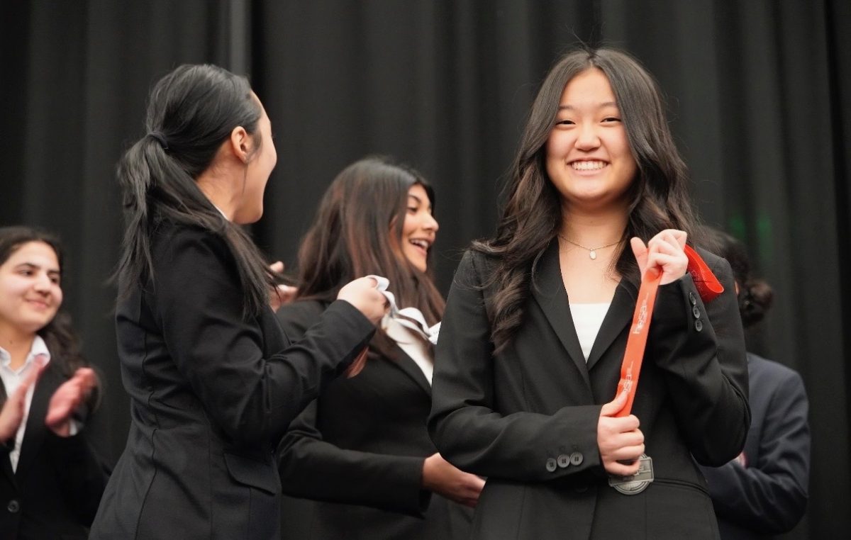 Abigail Shin, freshman, holds her second place medal for Research Persuasive Writing and Speaking.