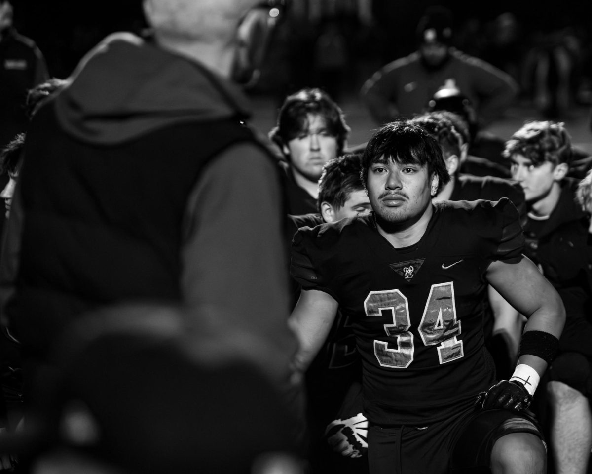 Jaydon Puni, junior, listens to his coach's speech after a playoff loss.